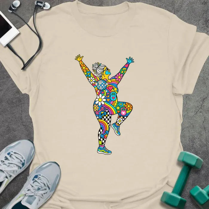Natural t-shirt printed with an older woman with a gray bun dancing with her arms up, her body filled with colorful flowers, rainbows, hearts, music notes and a disco ball