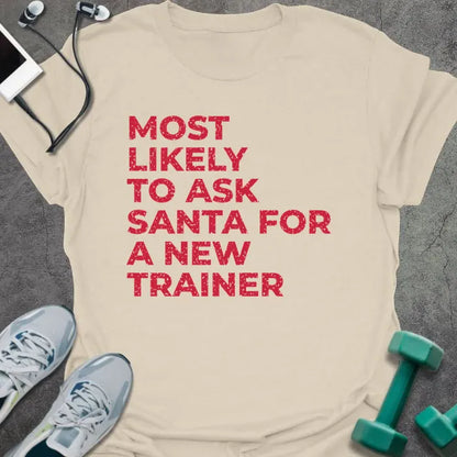 Natural t-shirt printed with "MOST LIKELY TO ASK SANTA FOR A NEW TRAINER" in red