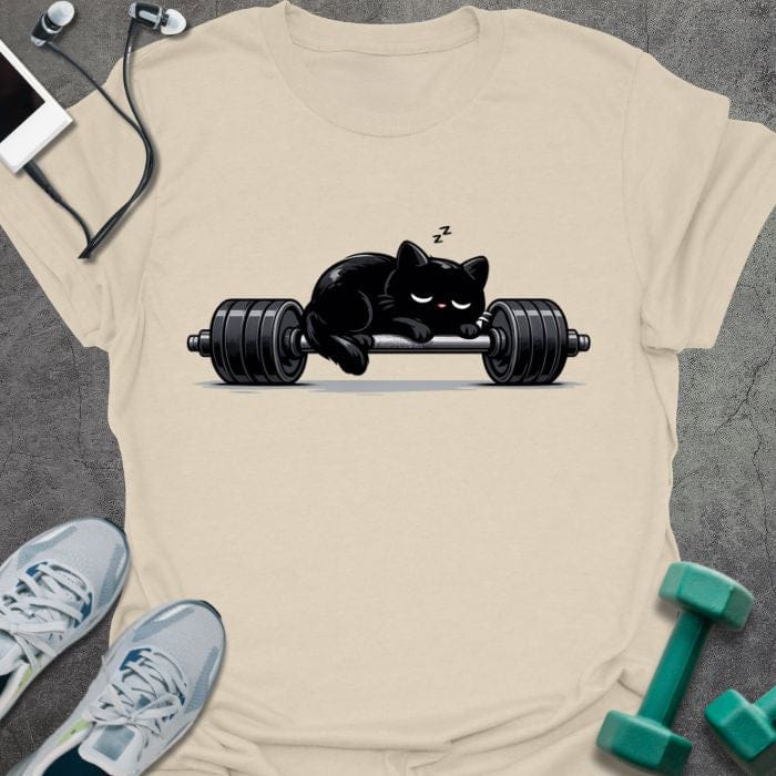 Cream t-shirt with an illustration of a black cat sleeping on a barbell in black