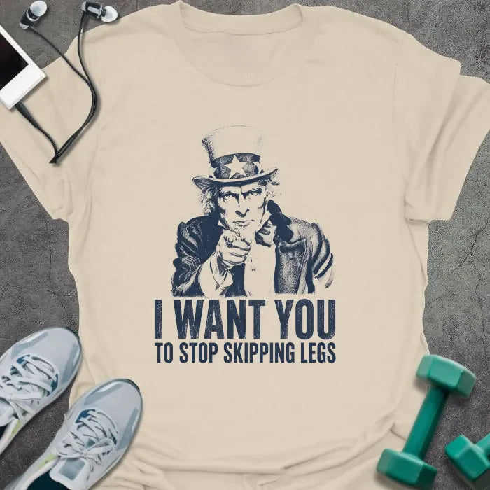 Cream t-shirt printed with "I Want You to Stop Skipping Legs" in navy, with an illustration of Uncle Sam pointing