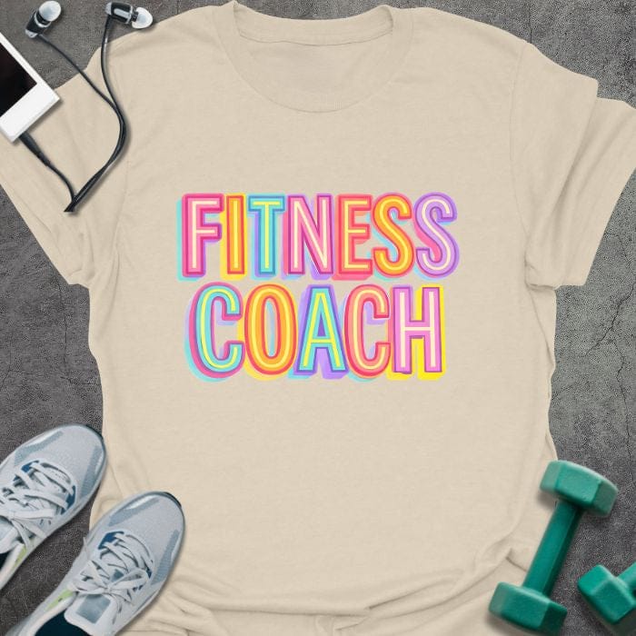 Cream t-shirt printed with "Fitness Coach" in multi-color