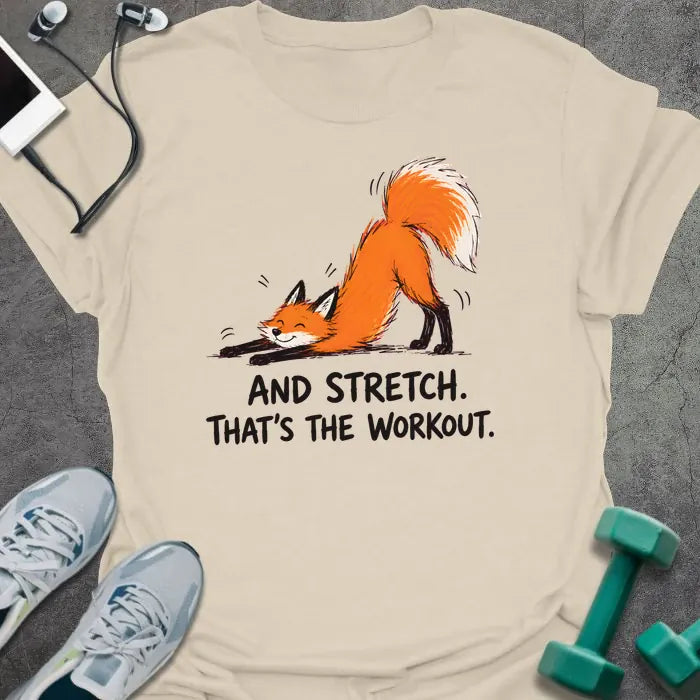 Natural t-shirt printed with "AND STRETCH. THAT'S THE WORKOUT." in black lettering, with a red fox in a stretching pose