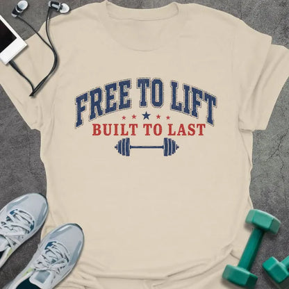 Cream t-shirt printed with "Free to Lift Built to Last" in blue and red, with stars and a barbell