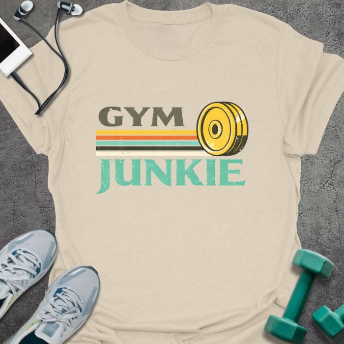Cream t-shirt printed with "Gym Junkie" in olive green, yellow, orange, white, with a yellow kettlebell and rainbow stripe
