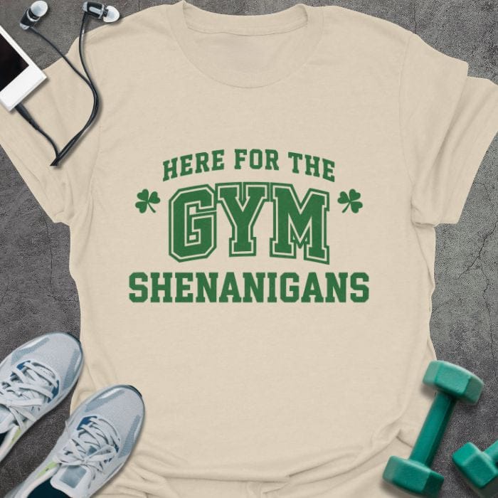 Cream t-shirt printed with "Here for the Gym Shenanigans" in green