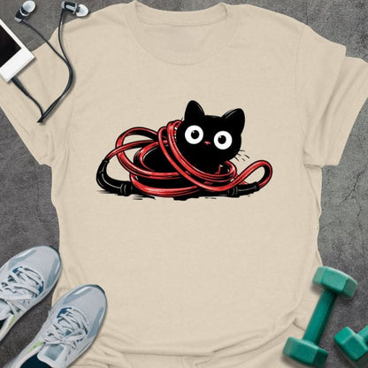 Cream t-shirt with a black cat tangled in a red jump rope in red, black, white