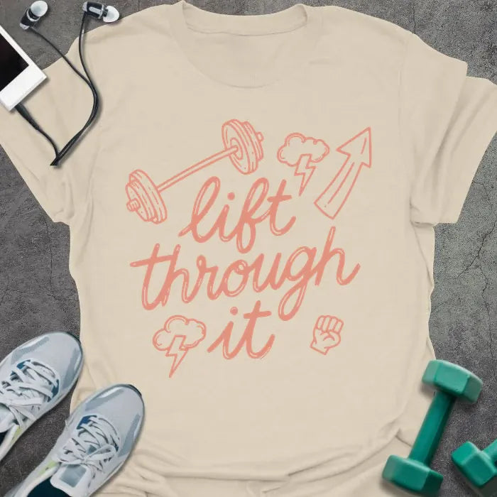 Cream t-shirt printed with "lift through it" in orange, with dumbbell, arrow up, fist graphics
