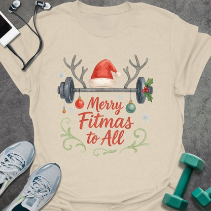 Cream t-shirt printed with "Merry Fitmas to All" in red and green, with a barbell and holiday decorations