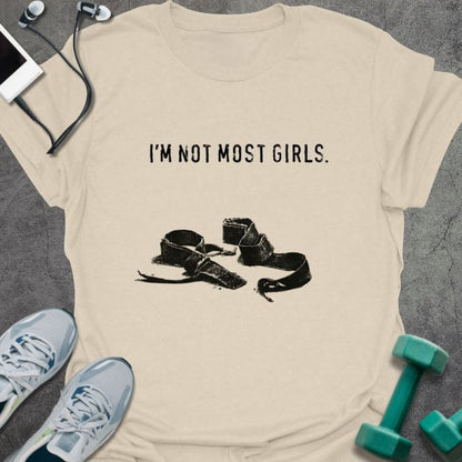 Cream t-shirt printed with "I'm Not Most Girls.", with lifting straps