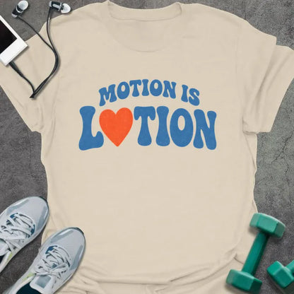 Natural t-shirt printed with "MOTION IS LOTION" in blue and orange, with heart icon
