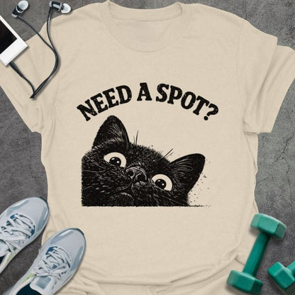 Cream t-shirt printed with "Need a Spot?" in black, with an illustration of a cat's face looking up