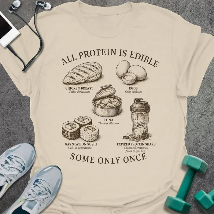Natural t-shirt printed with "ALL PROTEIN IS EDIBLE" in black text with sepia-tone engraving style illustrations and 'SOME ONLY ONCE' at bottom