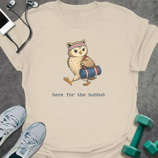 Cream t-shirt printed with "here for the hubbub", with an owl holding a dumbbell