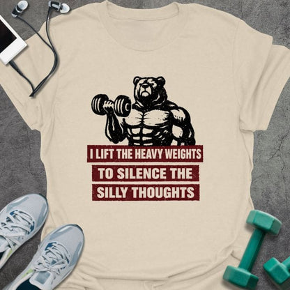 Cream t-shirt printed with "I Lift the Heavy Weights to Silence the Silly Thoughts" in red and black, with muscular bear lifting dumbbell