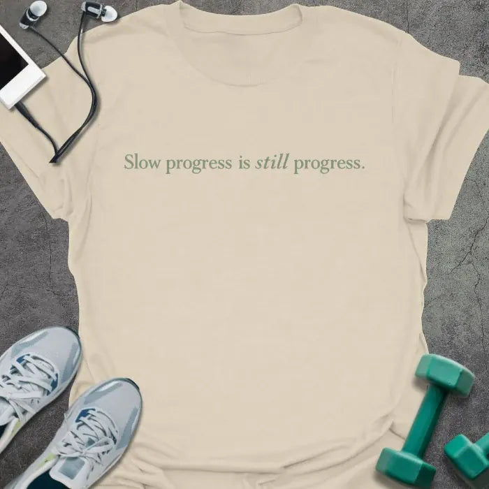 Cream t-shirt printed with "Slow progress is still progress."