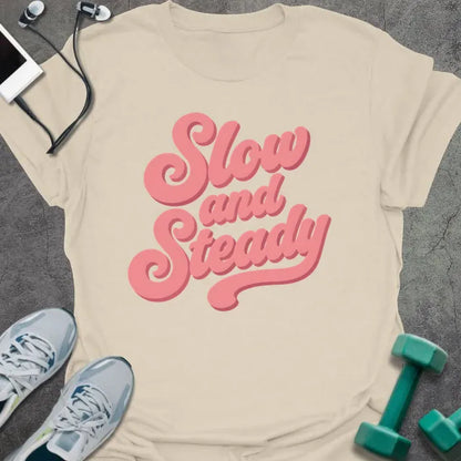 Natural t-shirt printed with "Slow and Steady" in rose and pink