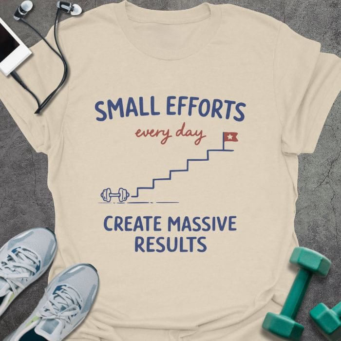 Cream t-shirt printed with "SMALL EFFORTS every day CREATE MASSIVE RESULTS" in red and blue, with stairs and flag illustration