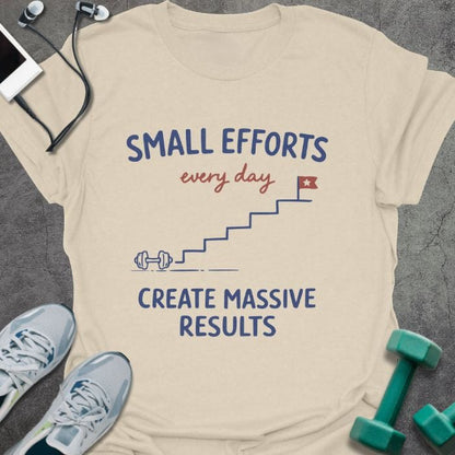 Cream t-shirt printed with "SMALL EFFORTS every day CREATE MASSIVE RESULTS" in red and blue, with stairs and flag illustration