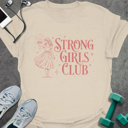 Cream t-shirt printed with "Strong Girls Club" in pink, with a girl illustration and sparkles