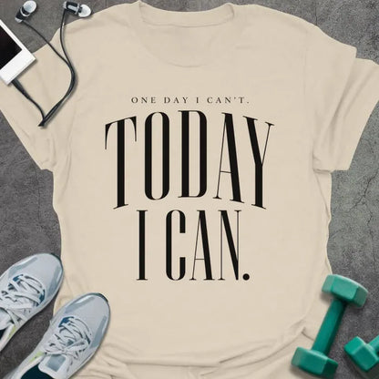 Natural t-shirt printed with "ONE DAY I CAN'T. TODAY I CAN." in black serif text