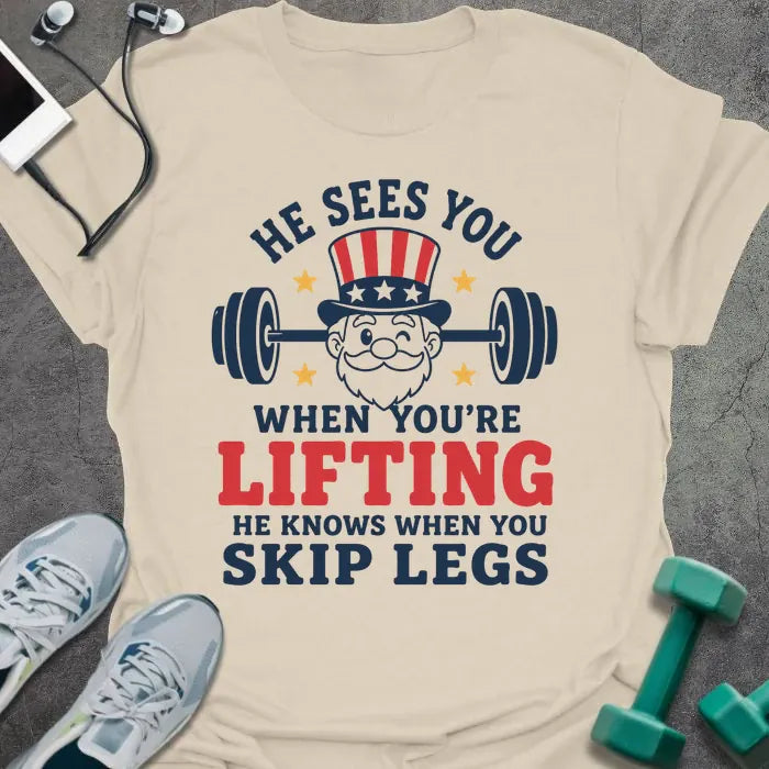 Cream t-shirt with an American flag person lifting dumbbells graphic in white and red