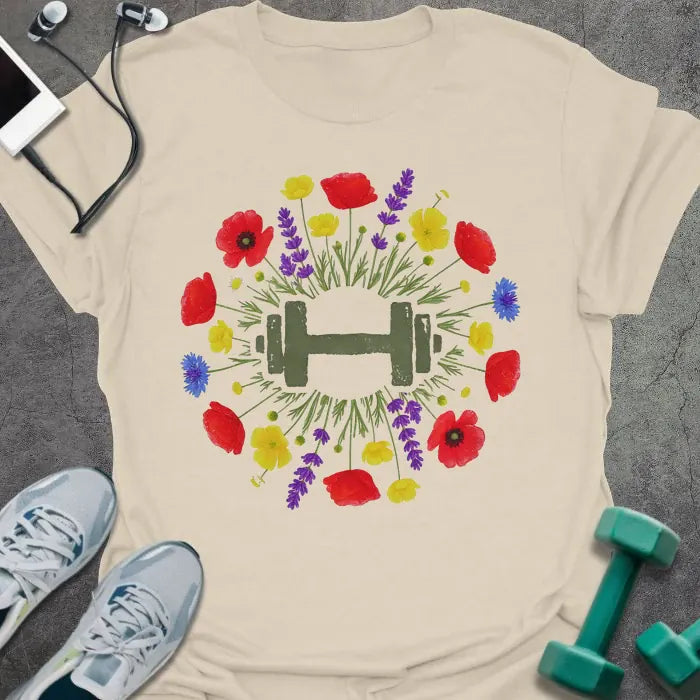 Cream t-shirt with an illustration of multicolor wildflowers surrounding a dumbbell in multicolor