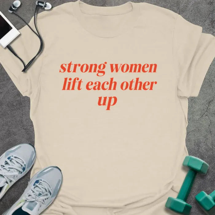 Natural t-shirt printed with "strong women lift each other up" in orange italic lettering