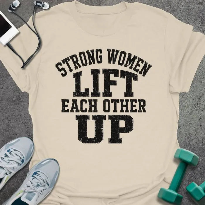 Natural t-shirt printed with "Strong Women Lift Each Other Up" in black varsity lettering