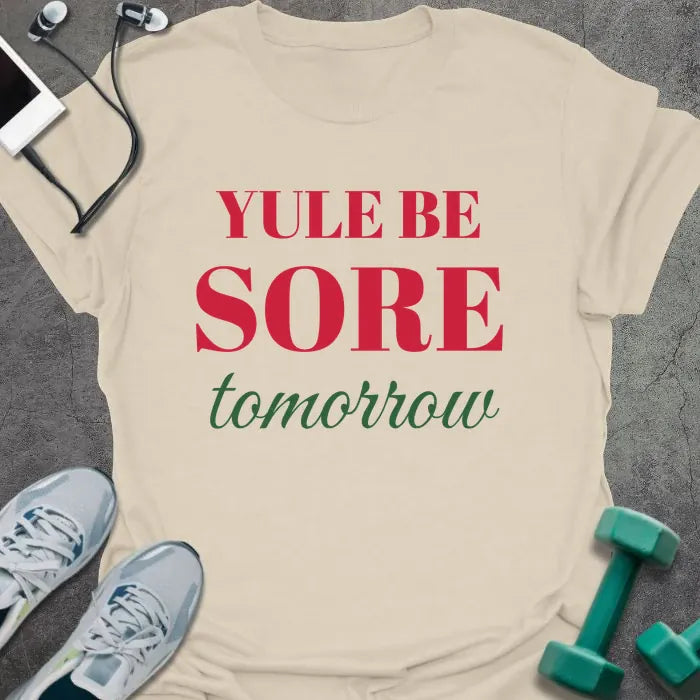 Natural t-shirt printed with "YULE BE SORE tomorrow" in red and green
