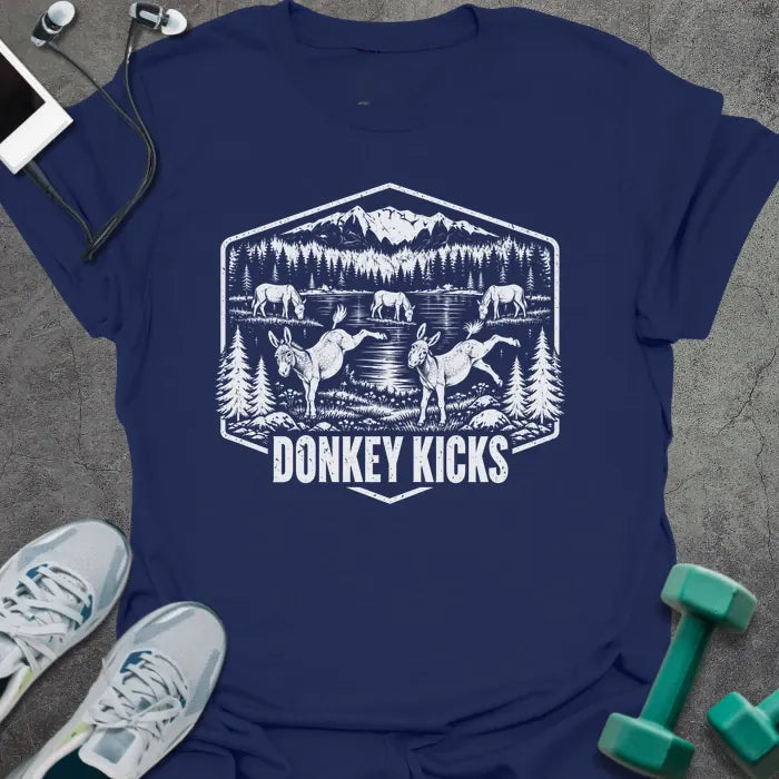 Navy t-shirt printed with "DONKEY KICKS" in white, with two donkeys kicking up their back legs by a mountain lake and pine trees