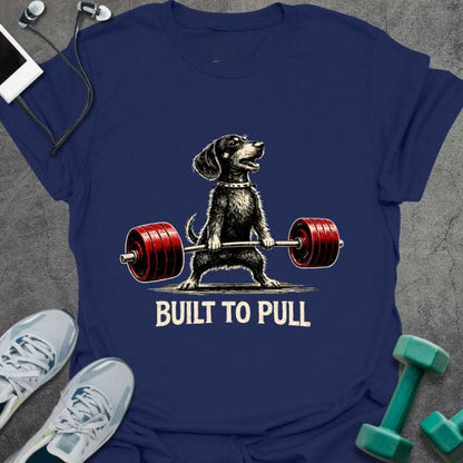 Navy t-shirt printed with "Built to Pull" in white, red, with a dog lifting a barbell