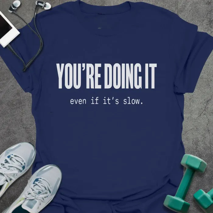 Navy t-shirt printed with "YOU'RE DOING IT even if it's slow." in white