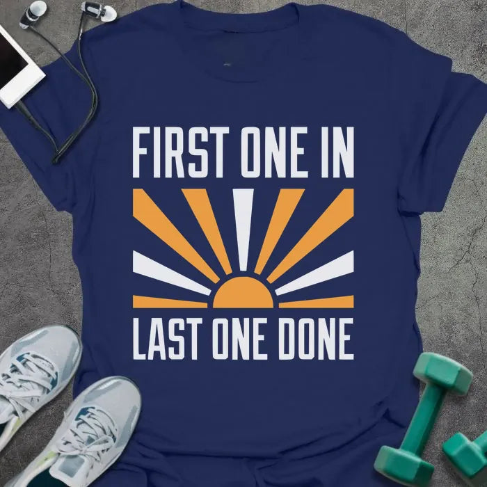 Navy t-shirt printed with "First One in Last One Done" in orange and white, with sun graphic