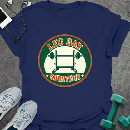 Navy t-shirt printed with "Leg Day Survivor" in orange and red, with barbell in circular badge