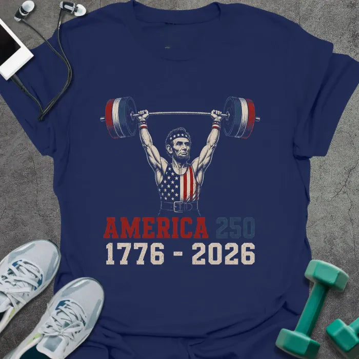 Navy t-shirt with Abraham Lincoln lifting dumbbells graphic in white and gold