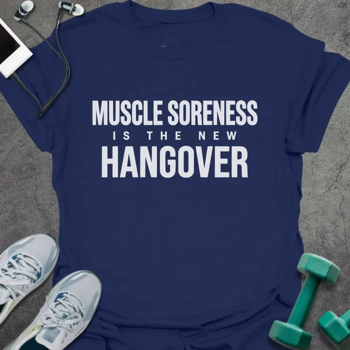 Navy t-shirt printed with "Muscle Soreness is the New Hangover" in white