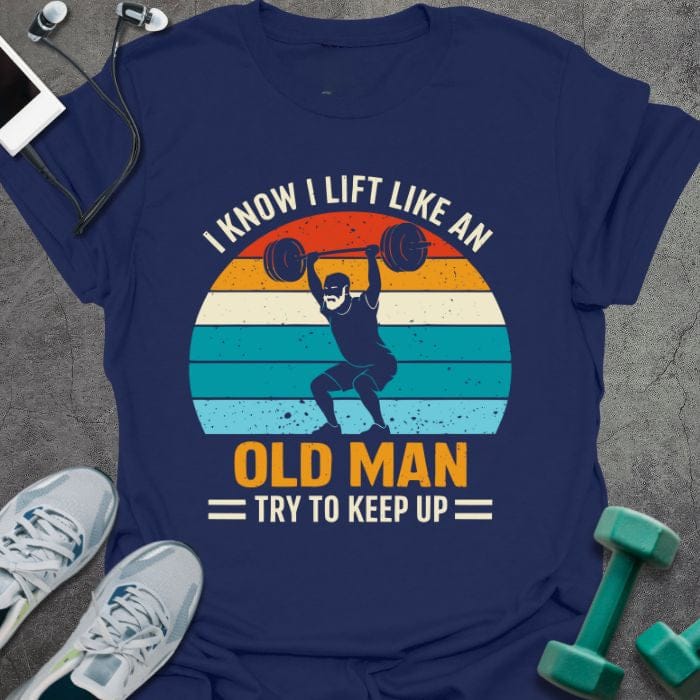 Navy t-shirt printed with "I Know I Lift Like an Old Man Try to Keep Up" in orange, white, green, light blue, with a person lifting and rainbow sunset background