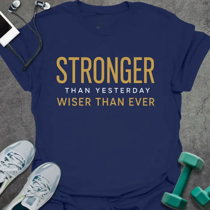 Navy t-shirt printed with "Stronger Than Yesterday Wiser Than Ever" in white and gold