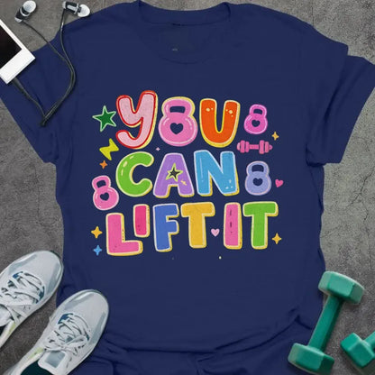 Navy t-shirt printed with "You Can Lift it" in pink, orange, green, purple, blue, yellow, with bubble letters, stars, sparkles, and small dumbbell doodles
