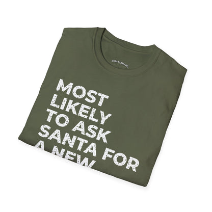 Folded military green t-shirt printed with "MOST LIKELY TO ASK SANTA FOR A NEW TRAINER" in white