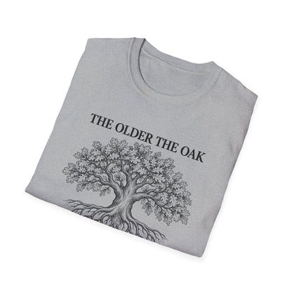 Folded sport grey t-shirt printed with "THE OLDER THE OAK, THE STRONGER IT STANDS" in black, with a drawing of an oak tree and its roots