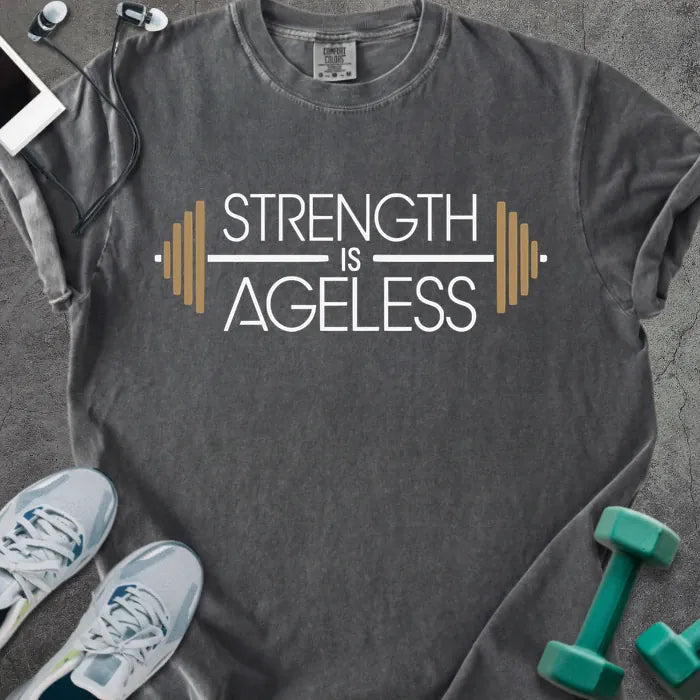 Pepper t-shirt printed with "Strength is Ageless" in white and gold, with a barbell graphic