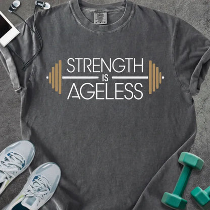 Pepper t-shirt printed with "Strength is Ageless" in white and gold, with a barbell graphic
