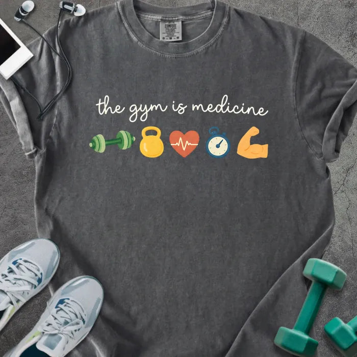 Pepper t-shirt printed with "the gym is medicine 💪 🏋️ 💓 ⏰ 💪" in white and multicolor