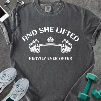 Pepper t-shirt printed with "And She Lifted Heavily Ever After" in white, with a barbell and crown