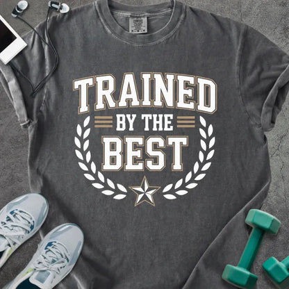 Pepper t-shirt printed with "Trained By the Best" in tan and white, with laurel wreath and star