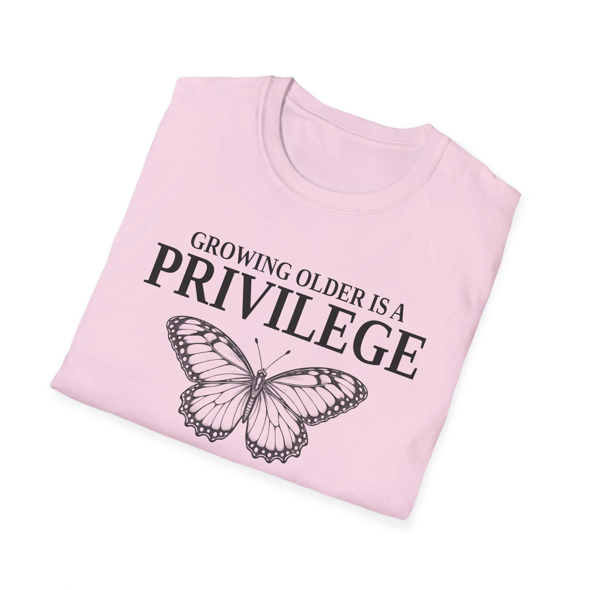 Folded light pink t-shirt printed with "GROWING OLDER IS A PRIVILEGE, GROWING STRONGER IS A CHOICE" in black, with a line-drawn butterfly