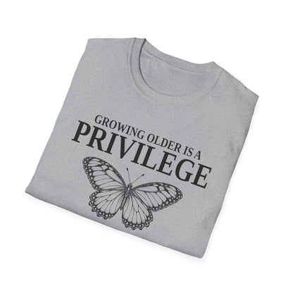Folded sport grey t-shirt printed with "GROWING OLDER IS A PRIVILEGE, GROWING STRONGER IS A CHOICE" in black, with a line-drawn butterfly
