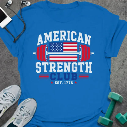 Royal blue t-shirt printed with "American Strength Club Est. 1776" in white, red, and blue, with a stars-and-stripes barbell and eagle