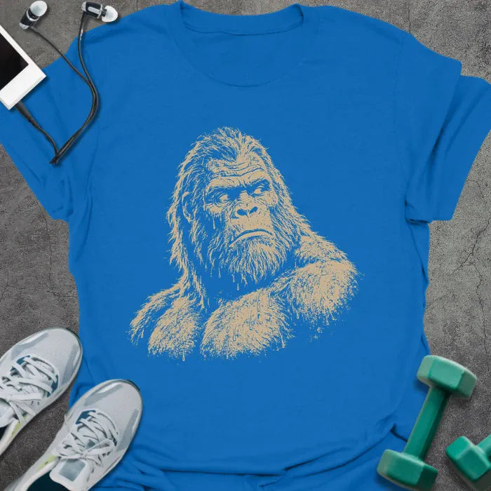 Royal blue t-shirt with an illustration of Bigfoot's face looking to the side in white